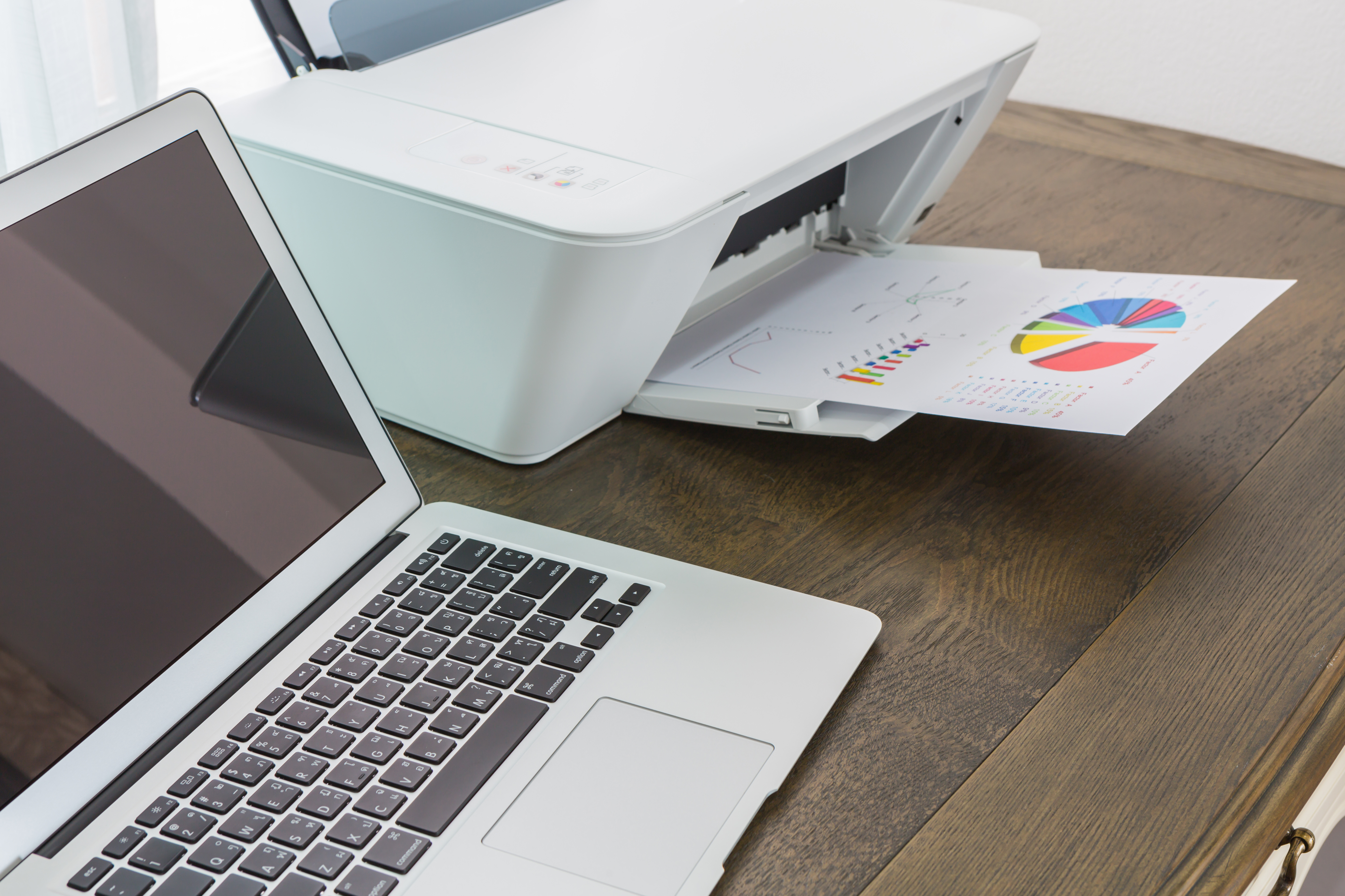 printer and Laptop on wood table